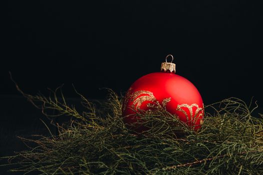 Christmas New Year decoration composition. Top view of fur-tree branches and balls frame on wooden background with place for your text.