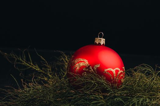 Christmas New Year decoration composition. Top view of fur-tree branches and balls frame on wooden background with place for your text.