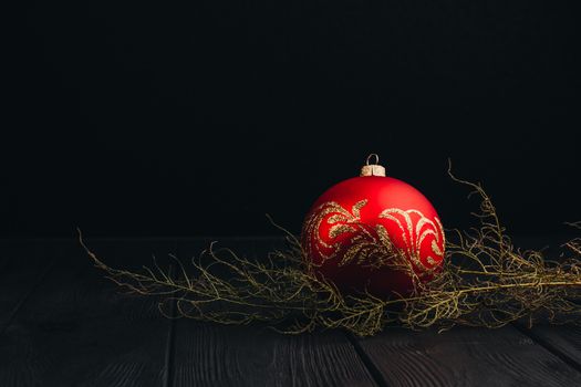 Christmas New Year decoration composition. Top view of fur-tree branches and balls frame on wooden background with place for your text.