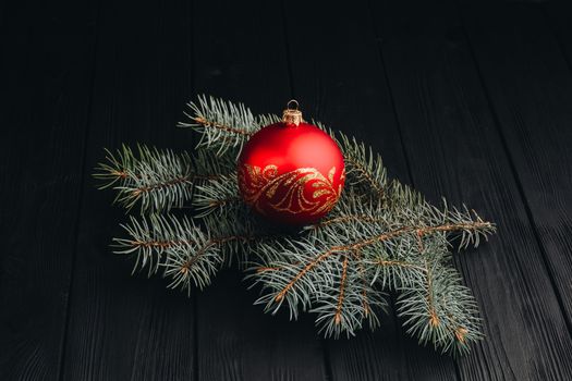 Christmas New Year decoration composition. Top view of fur-tree branches and balls frame on wooden background with place for your text.