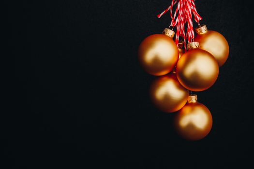 golden Christmas balls in hand isolated on black background. new year card