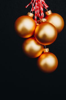 golden Christmas balls in hand isolated on black background. new year card