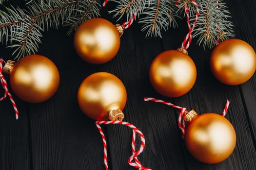 Colored christmas decorations on black wooden table. Xmas balls on wood background. Top view, copy space. new year