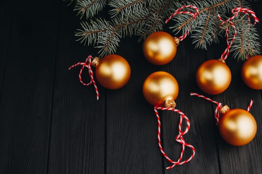 Colored christmas decorations on black wooden table. Xmas balls on wood background. Top view, copy space. new year