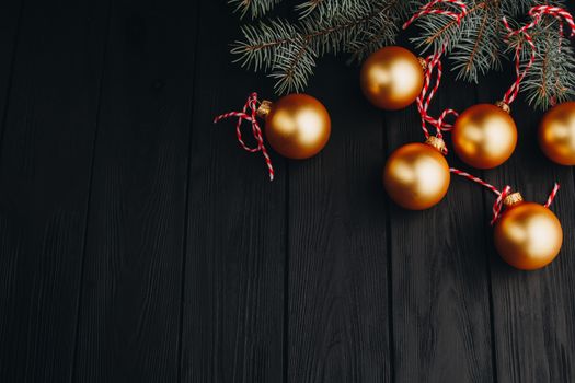 Colored christmas decorations on black wooden table. Xmas balls on wood background. Top view, copy space. new year