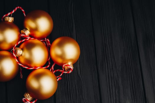 Colored christmas decorations on black wooden table. Xmas balls on wood background. Top view, copy space. new year