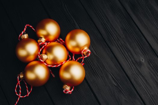 Colored christmas decorations on black wooden table. Xmas balls on wood background. Top view, copy space. new year