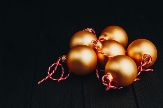 Colored christmas decorations on black wooden table. Xmas balls on wood background. Top view, copy space. new year