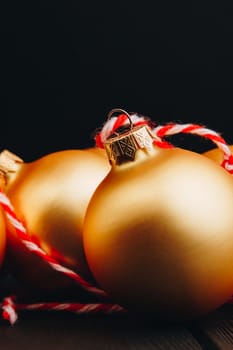 Colored christmas decorations on black wooden table. Xmas balls on wood background. Top view, copy space. new year