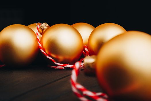 Colored christmas decorations on black wooden table. Xmas balls on wood background. Top view, copy space. new year