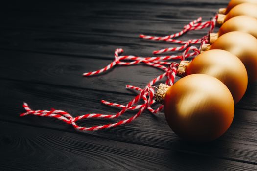 Colored christmas decorations on black wooden table. Xmas balls on wood background. Top view, copy space. new year