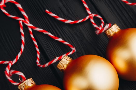 Colored christmas decorations on black wooden table. Xmas balls on wood background. Top view, copy space. new year