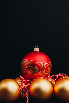 Colored christmas decorations on black wooden table. Xmas balls on wood background. Top view, copy space. new year