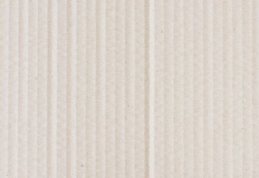 Beige background of kraft corrugated cardboard closeup