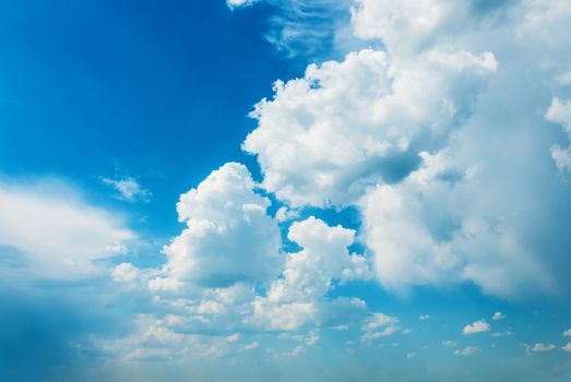 Panorama of vast blue summer sky with fluffy white cumulus clouds