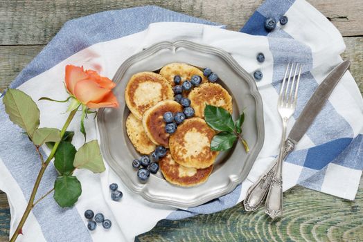 Breakfast of pancakes with ripe blueberry, top view