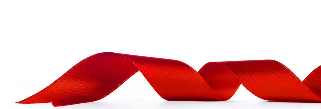 Fabric red ribbon isolated on a white background