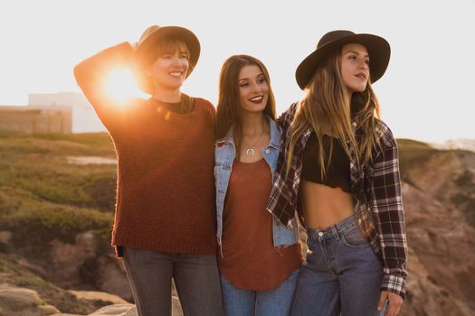 Three best friends near the coastline having a good time