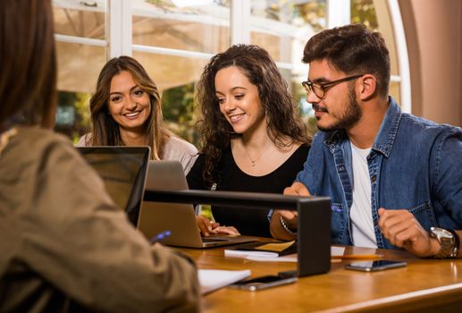 Groups of friends studying together on the bibliotech