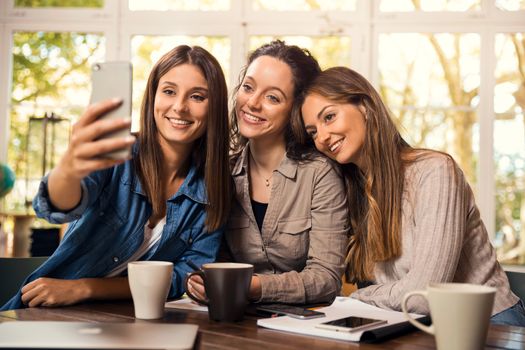Groups of female firends making a selfie during a pause on the studies