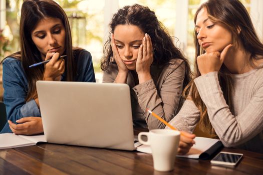 Group of friends studying together and worried with final exams