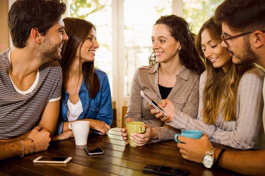 A group of friends talking and drinking coffee at the cafe