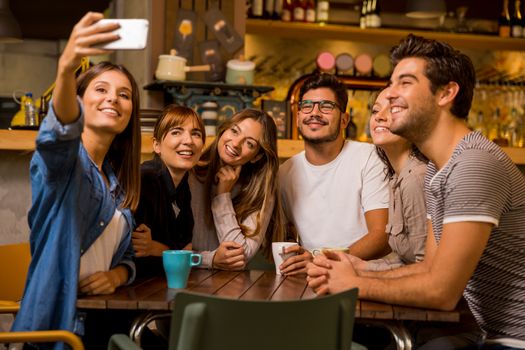 Group of friends taking a selfie at the cafe 