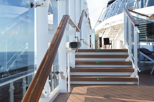 View of the wooden stairs on the open deck of a luxury cruise liner.