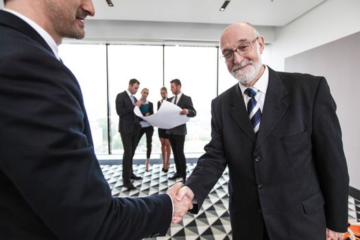 Business meeting of architects and investors shaking hands in office