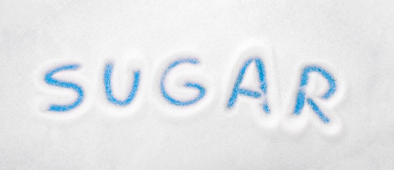 White sugar background - Sugar written - Concept of unhealthy eating