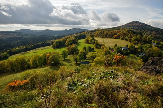Autumn colorful landscape with forests, hills, sun and sky