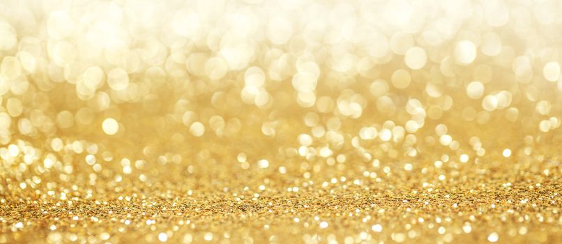 Abstract golden glitter light bokeh holiday party background