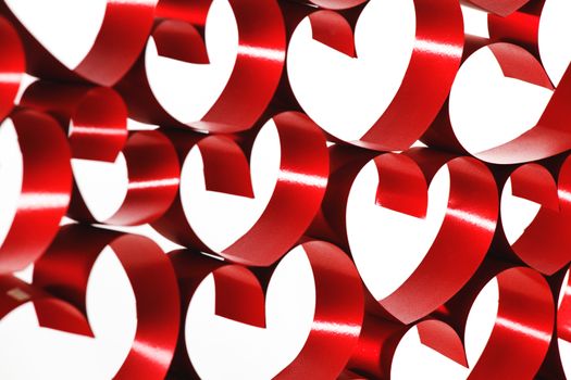 Linked red ribbon hearts isolated on white background