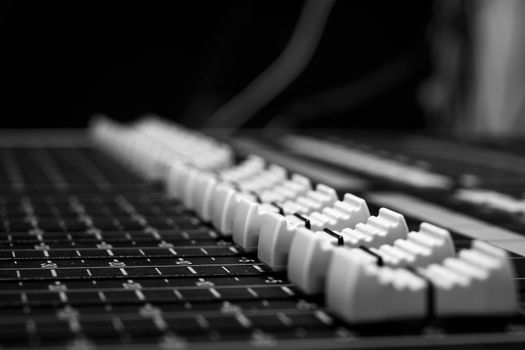 Monochrome style Professional Audio Sound Mixing Console Faders, black desk and white controller Faders