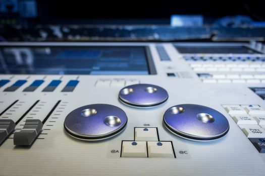Silver digital encoders and Faders on white pro Lighting Designers festival Console