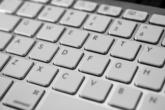 cloesup of a qwerty computer keyboard in white with black numbers and letters