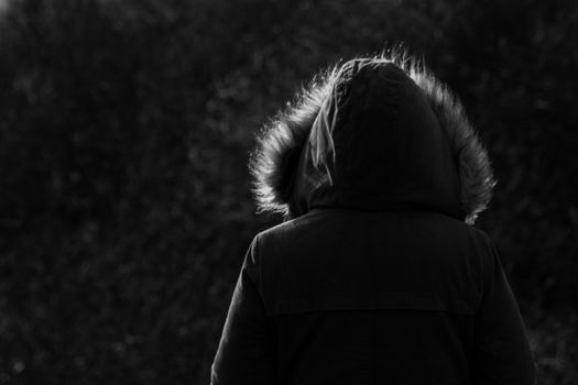 Girl Wearing Fur Hooded Parker Jacket From Behind woodland background