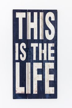 This Is The Life Printed/ Painted on rustic black  wooden surface and white lettering, isolated on white background