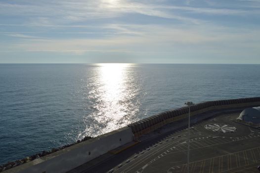 Beautiful sunset and silver path on the sea, blue clouds in the sky, background.