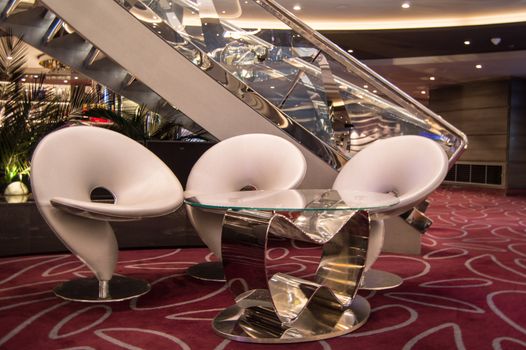 Cruise ship furniture, comfortable modern chairs in the reception area, MSC Meraviglia, 8 October 2018.