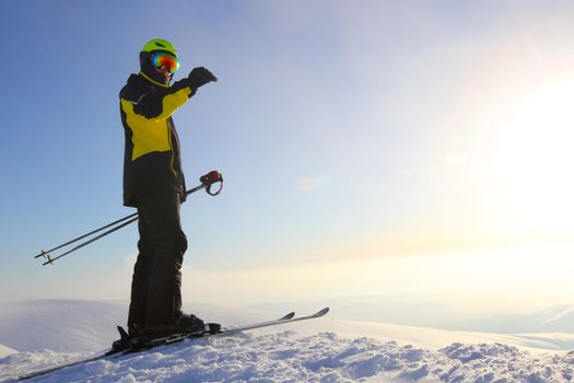 Skier on ski slope with mountains in background