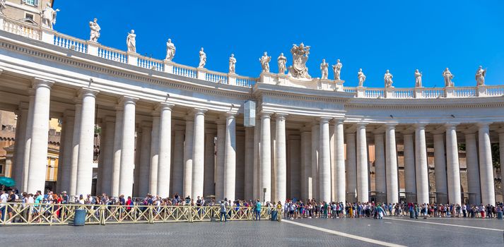 ROME, VATICAN STATE - AUGUST 24, 2018: long line of people waiting in front of Saint Peter Basilica entrance. Concept for overtourism and mass-tourism.