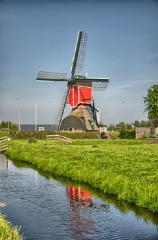 Windmills and water canal in Kinderdijk, Holland or Netherlands. Unesco world heritage site. Europe. HDR