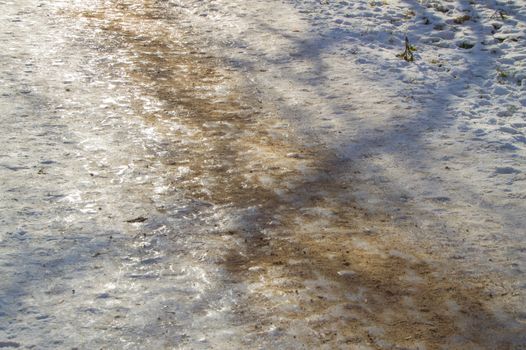 Ice track, sanded, removes ice slippery road close up.