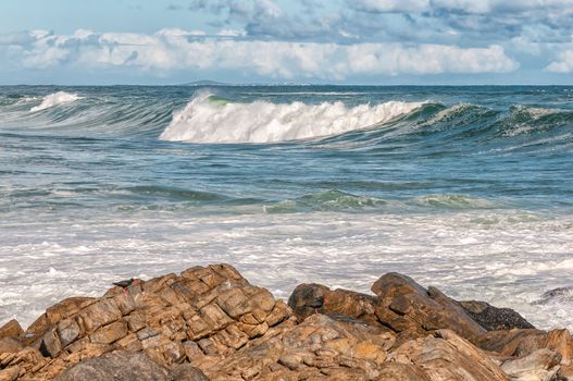A view of the Atlantic Ocean at Tsaarsbank in Postberg near Langebaan in the Western Cape Province of South Africa. Two endangered African Black Oystercatchers are visible on the rocks