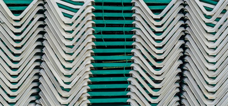 pattern of deckchairs stacked on a pile summer season beach holiday background