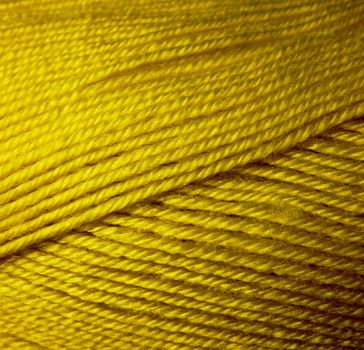 Skein of wool yarn. Macro shooting. Texture of wavy thread. Yellow green threads. Background image. Hobbies leisure crafts