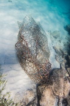 metal cage lying on the bottom of the ocean