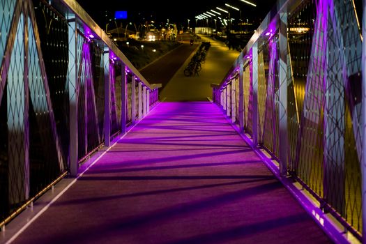 beautiful walking bridge with purple lights urban cityscape in scheveningen the netherlands