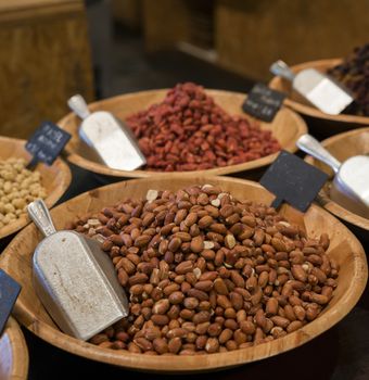 desk in a shop with peanuts walnuts hazelnuts and other nuts for selling and consumption